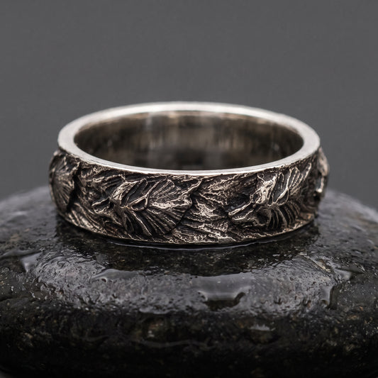 Hand-carved 925 silver Fenrir wolf band seen front on, wolf heads and manes in oxidised relief