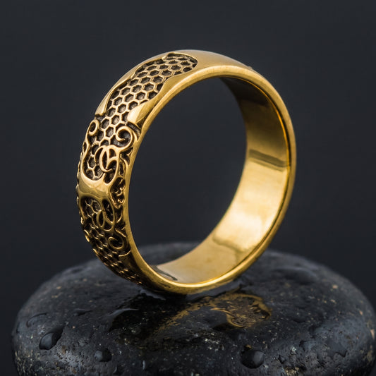 Handmade gold Viking ring standing upright, honeycomb scales and Norse scrollwork