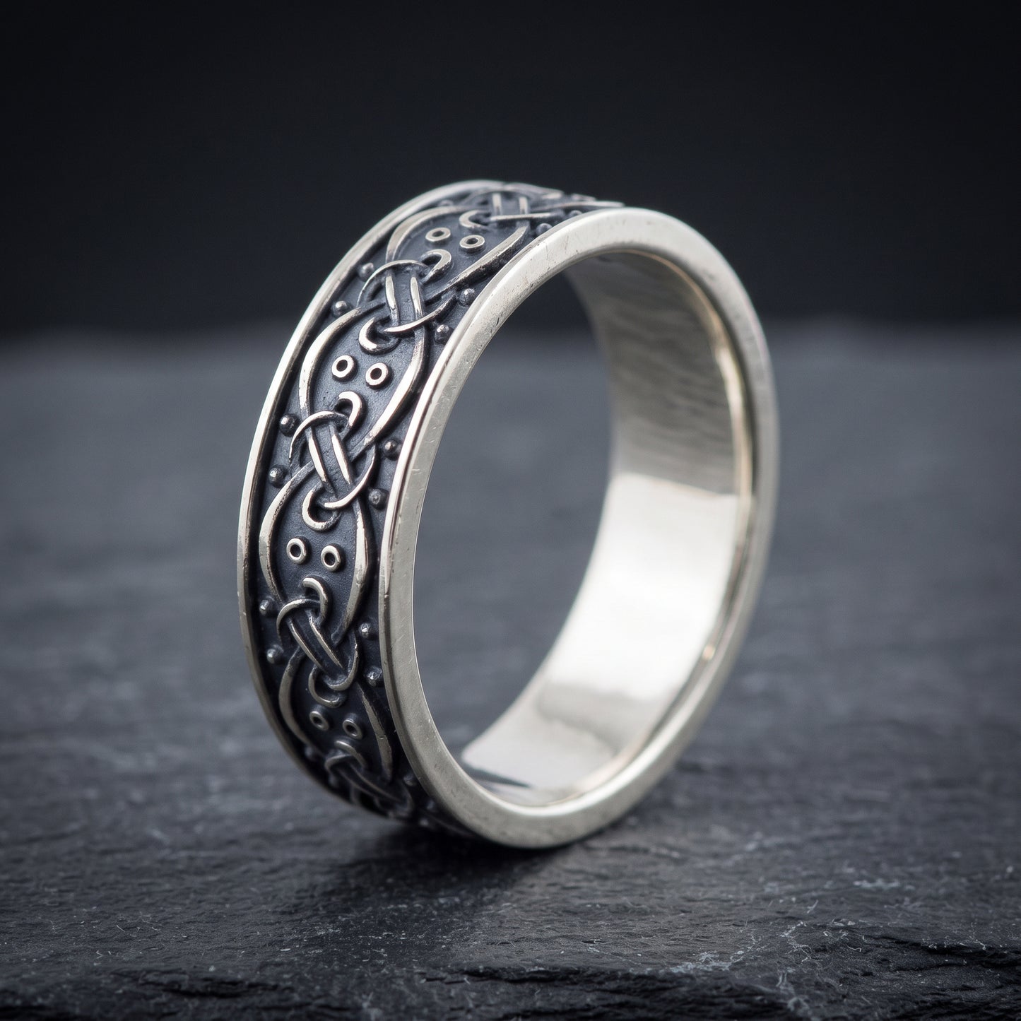Silver interlace ring from the side, polished interior visible