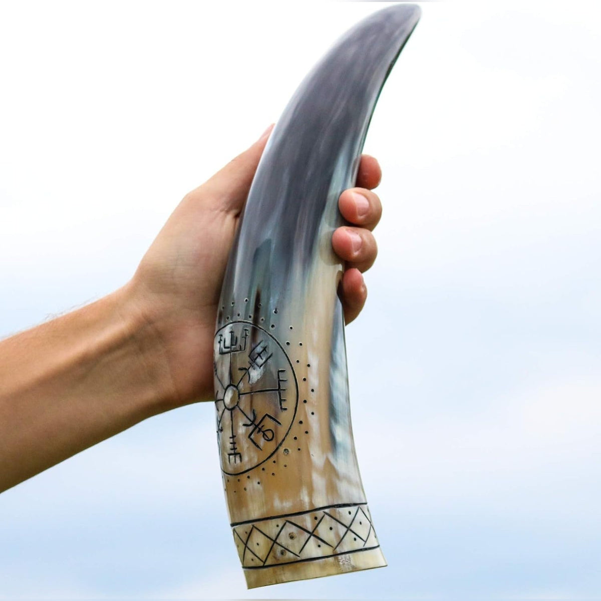 Vegvisir drinking horn held up against the sky, cream at the rim shading to black