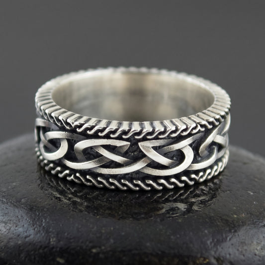 Sterling silver Viking ring seen front on, plaited Norse knot between two twisted rope borders