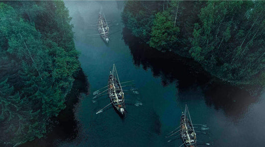 Viking longships sailing through narrow river passage