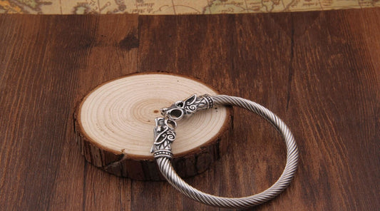 Silver Viking bracelet on a brown table