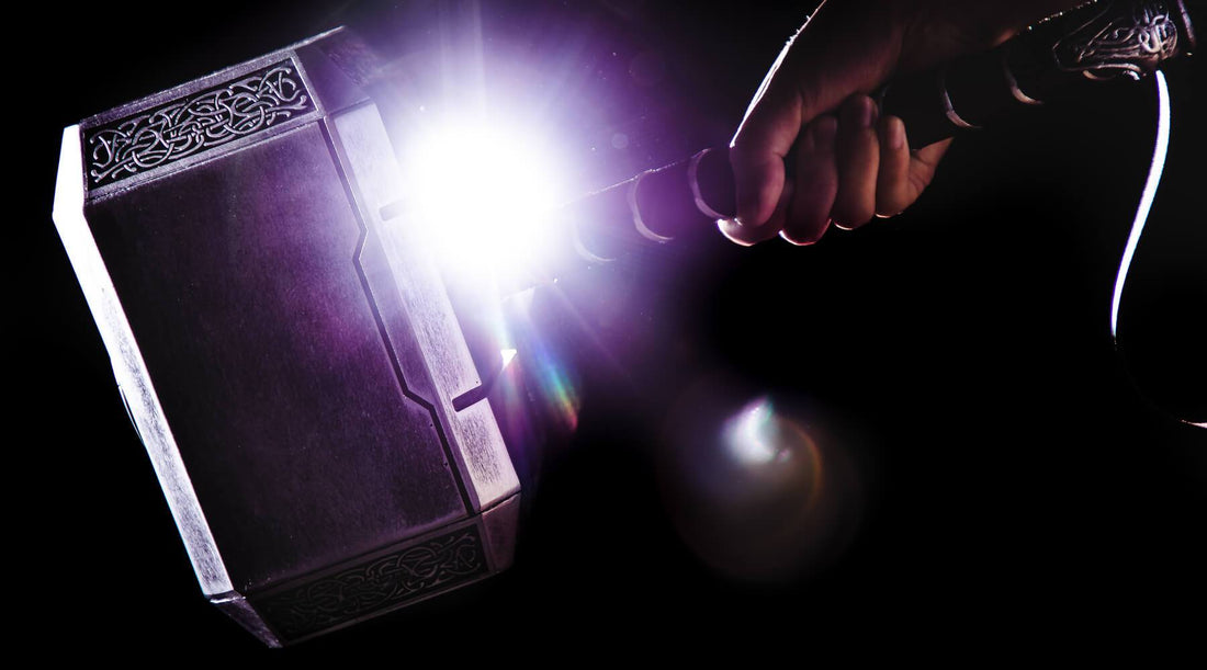 A hand holding Thor's hammer- Mjolnir