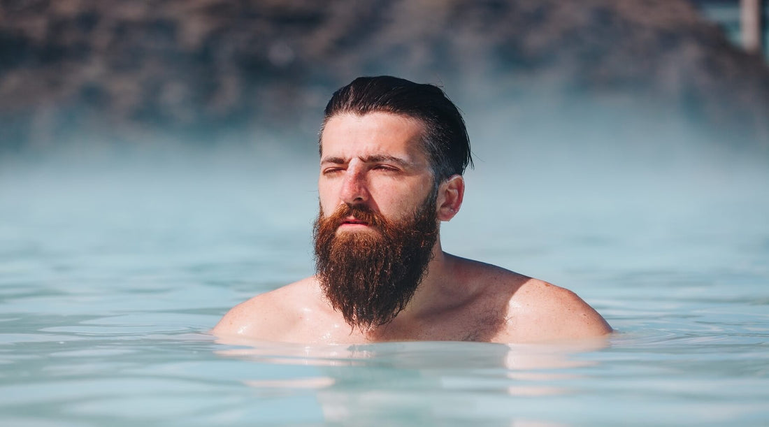 A Viking with a full beard in a hot spring