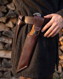 Broken-Back Viking seax knife carried in its plain slip sheath tucked behind a leather belt at the hip
