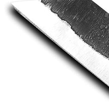 Macro view of the angled broken-back point and the line where forge skin meets the hand-ground bevel on the carbon steel blade