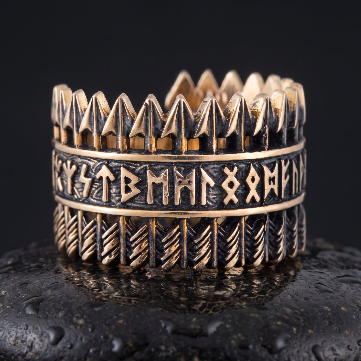 Handmade bronze Viking ring seen front on, openwork arrows above and below a runic band