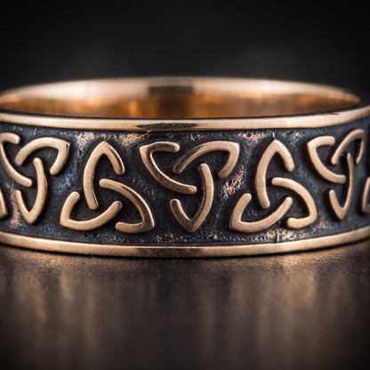 Macro of the raised bronze triquetra knots on the dark oxidised channel