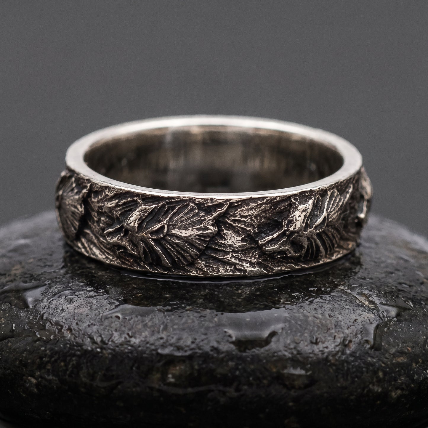 Hand-carved 925 silver Fenrir wolf band seen front on, wolf heads and manes in oxidised relief