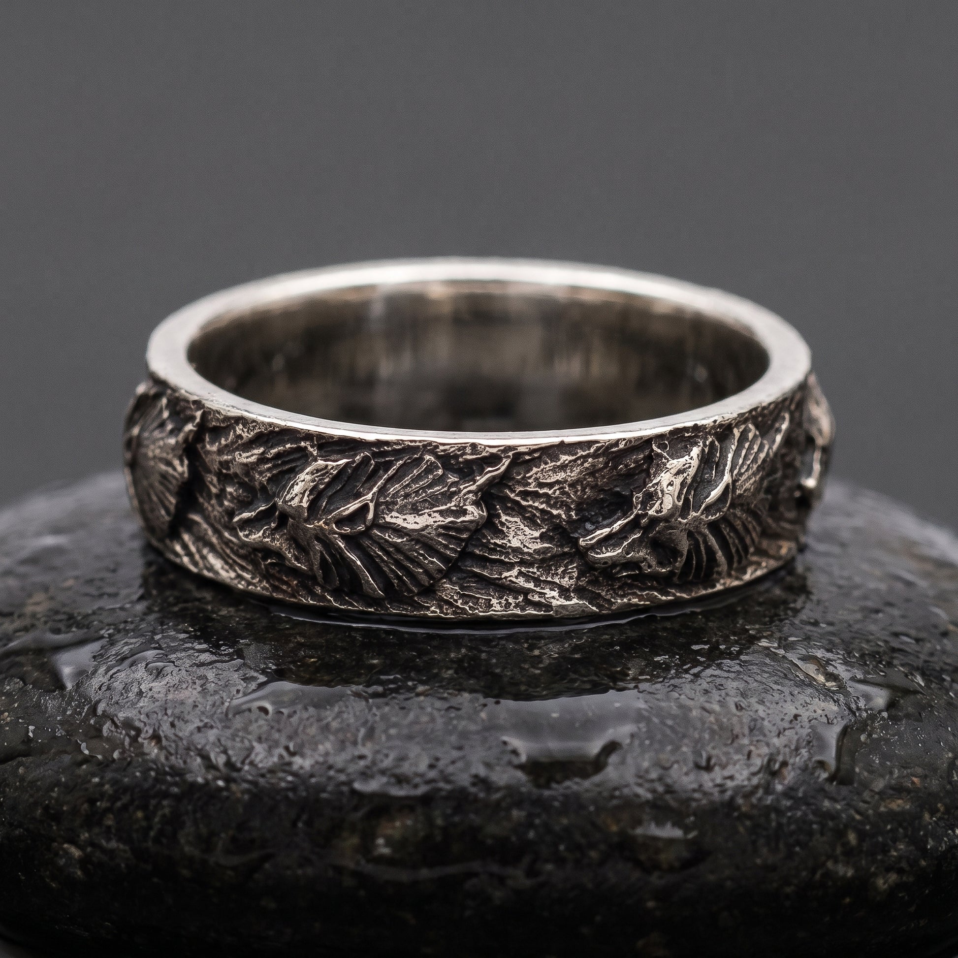 Hand-carved 925 silver Fenrir wolf band seen front on, wolf heads and manes in oxidised relief