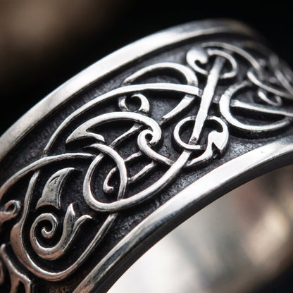 Macro of the fine Urnes-style interlace in thin raised silver lines