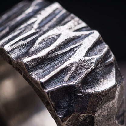 Macro of the hand-hammered, chisel-faceted silver surface