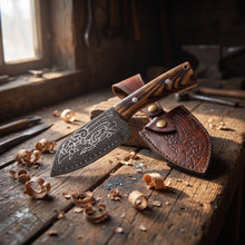 Huginn & Muninn Viking seax knife and its raven-embossed leather sheath on a blacksmith's oak workbench among wood shavings