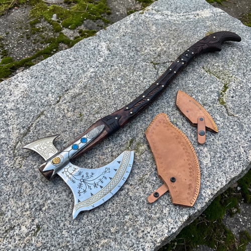 Kratos Leviathan axe with gold-tone knotwork edge and black rune etching, shown with its two leather blade covers