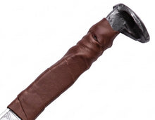 Close-up of the broad forged steel pommel and leather-wrapped grip on the langseax Viking seax knife