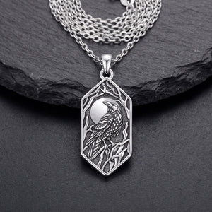 Front view of the sterling silver raven pendant: full moon, raven on a branch and bare branches in oxidized relief