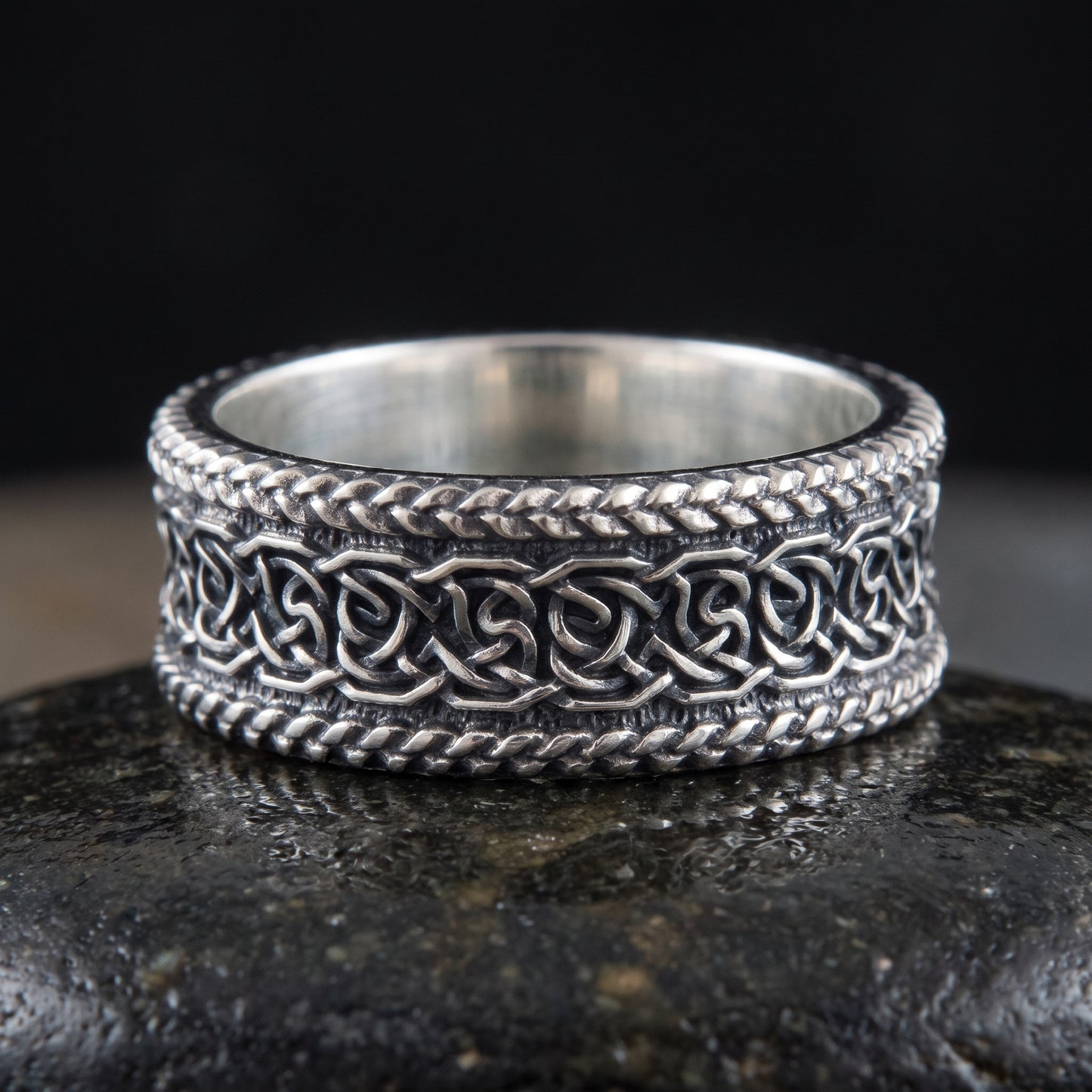 Handmade 925 silver Viking ring seen front on, interlaced knotwork in an oxidised channel