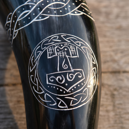 Close-up of the hand-engraved Thor's hammer in a knotwork ring on the drinking horn