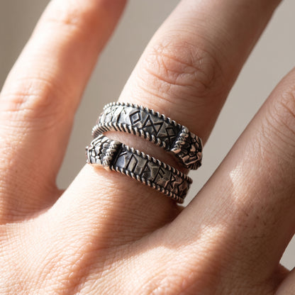 Silver Ouroboros rune ring worn on a finger