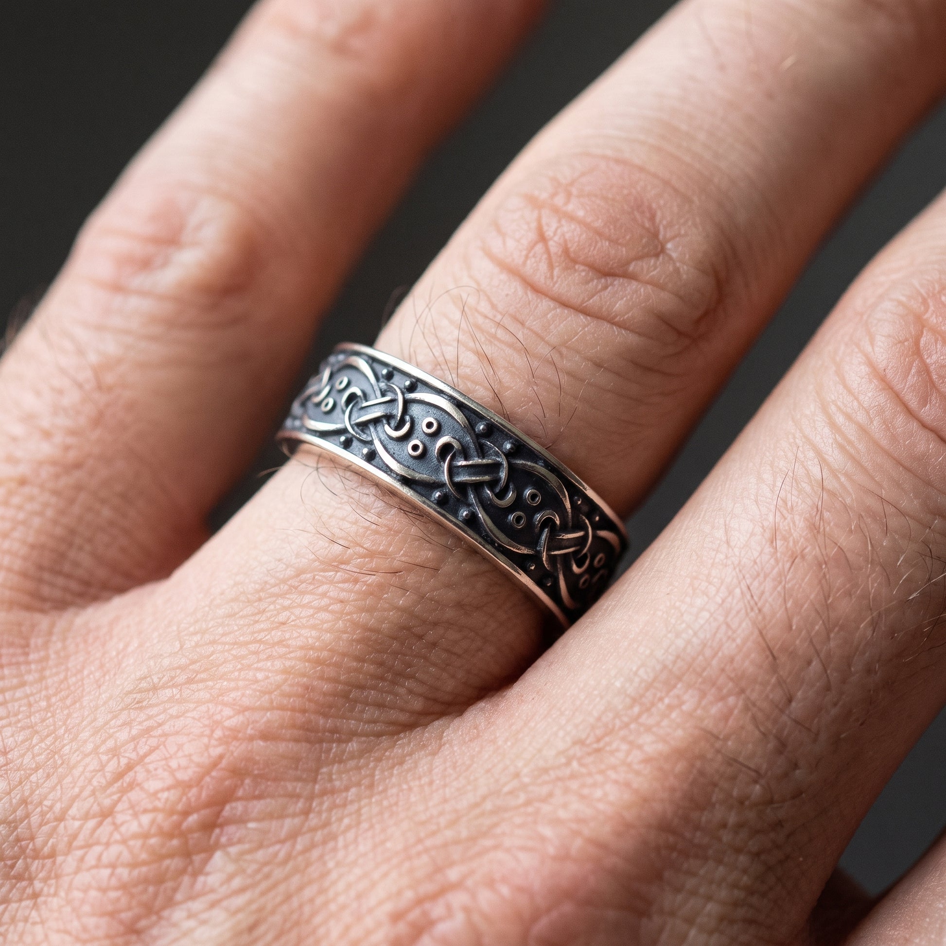Blackened silver interlace Viking ring worn on a finger