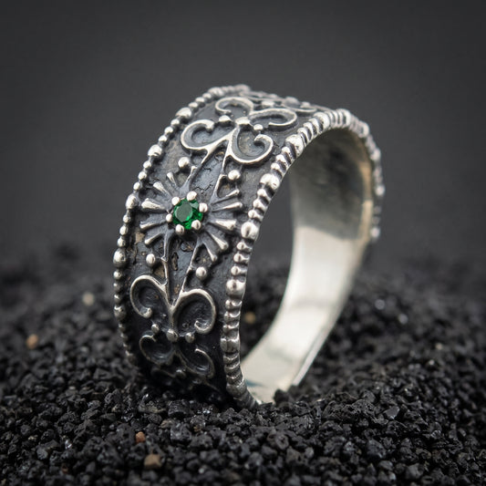 Sterling silver Viking ring with pagan-style ornament and a green stone