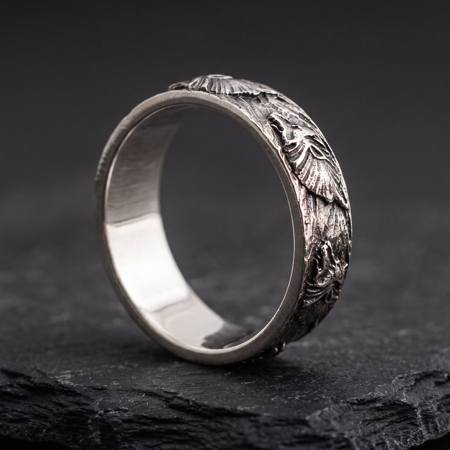 Hand-carved silver Fenrir wolf ring from the side, smooth polished interior