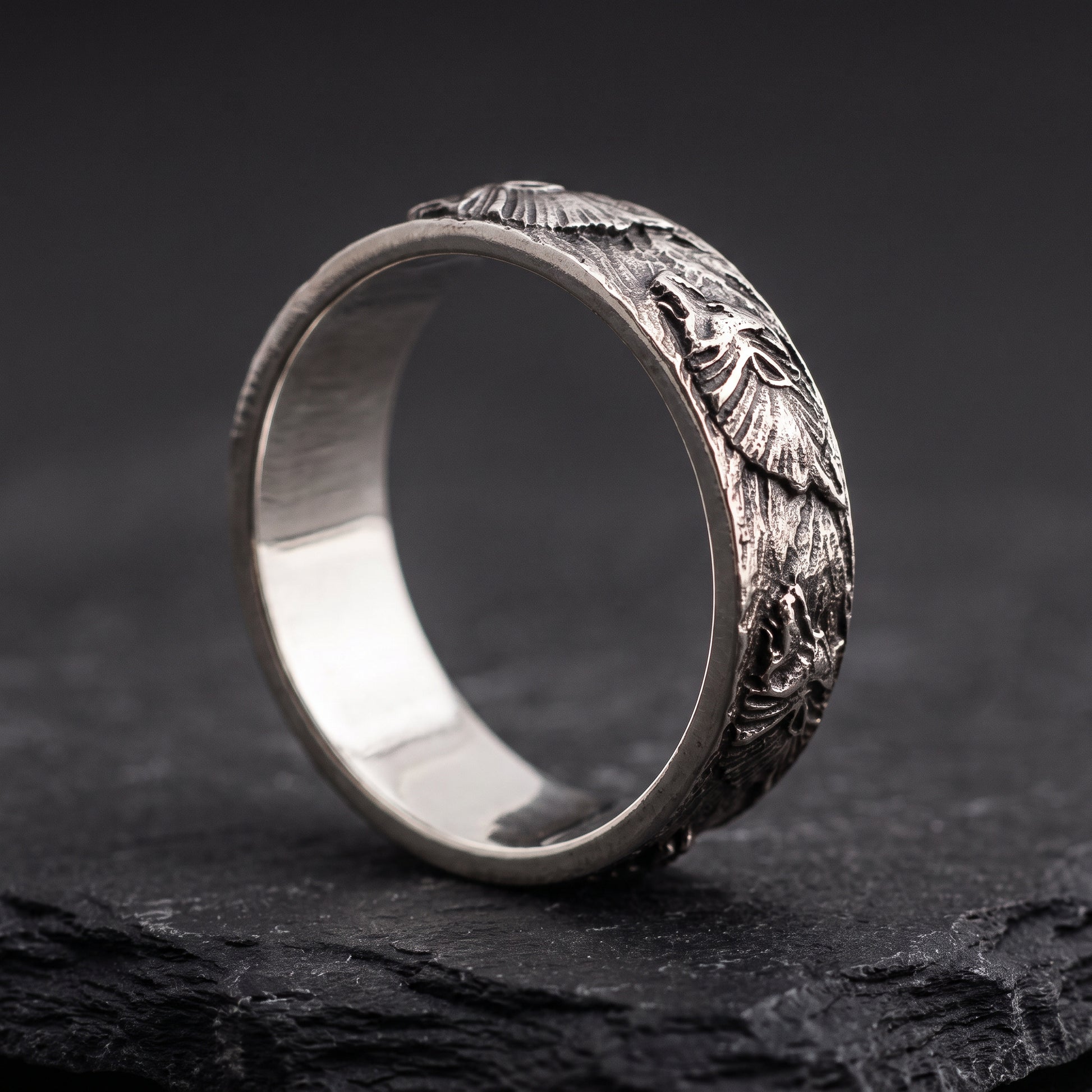Hand-carved silver Fenrir wolf ring from the side, smooth polished interior