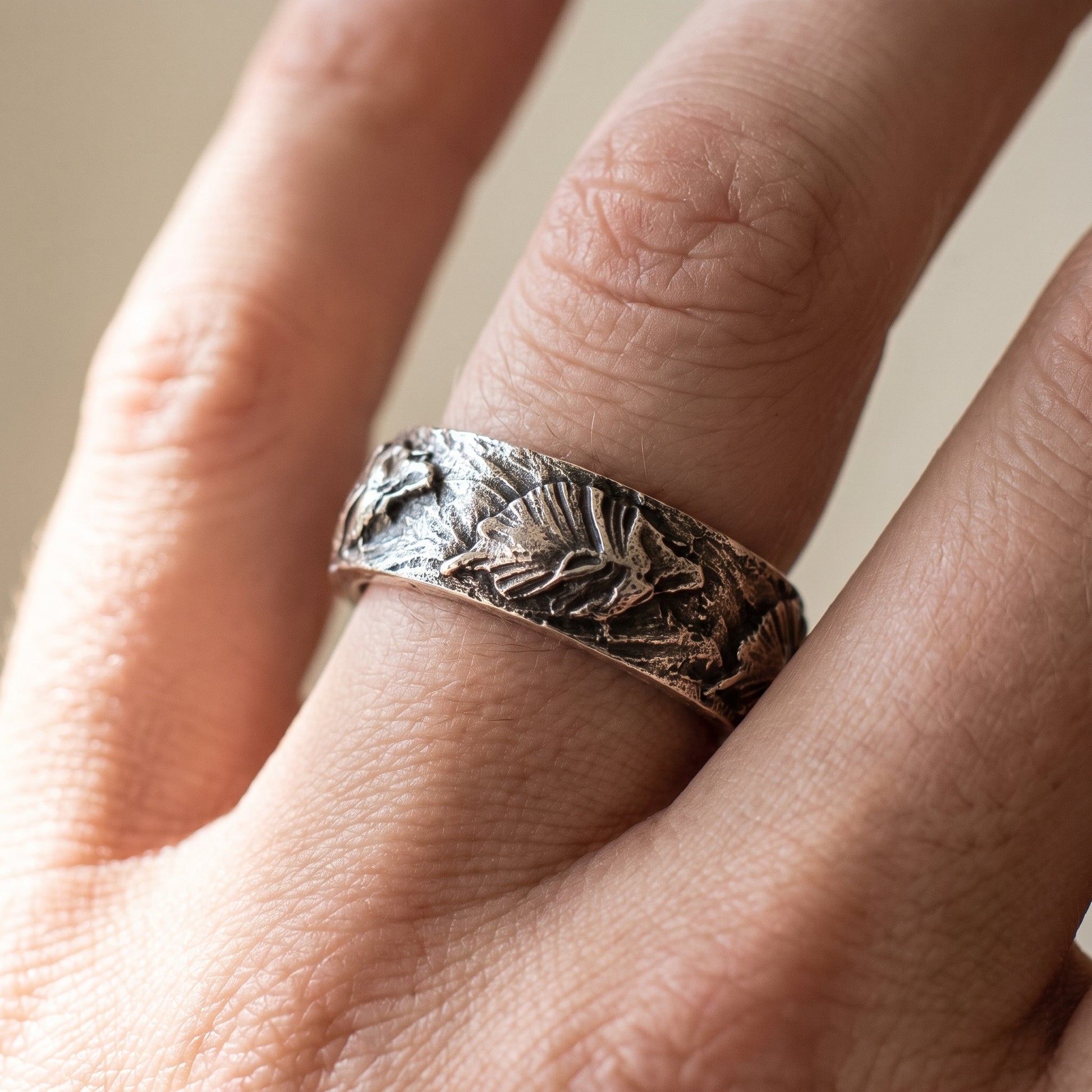 Hand-carved silver Fenrir wolf ring worn on a finger