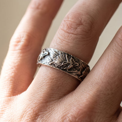 Hand-carved silver Fenrir wolf ring worn on a finger