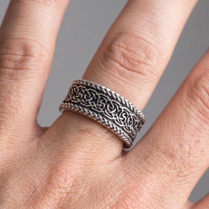 Silver Viking wedding ring with Norse knotwork worn on a finger