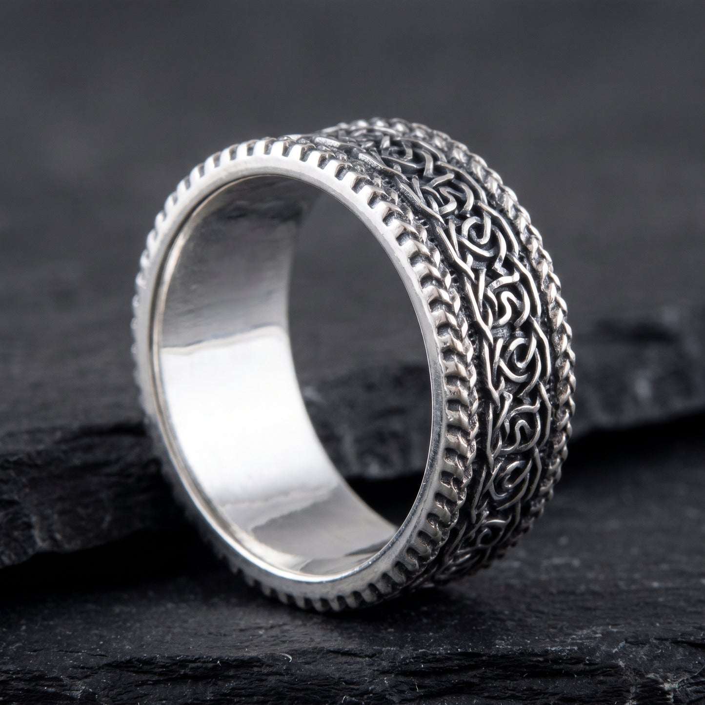Silver Viking knotwork ring from the side, polished interior visible