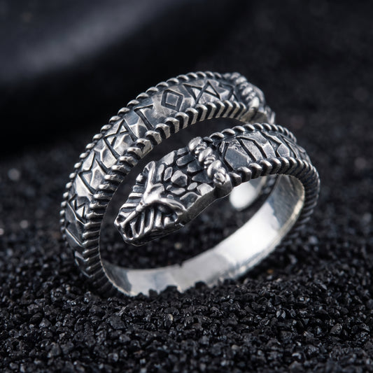 Sterling silver Ouroboros Viking ring with Elder Futhark runes on black volcanic sand