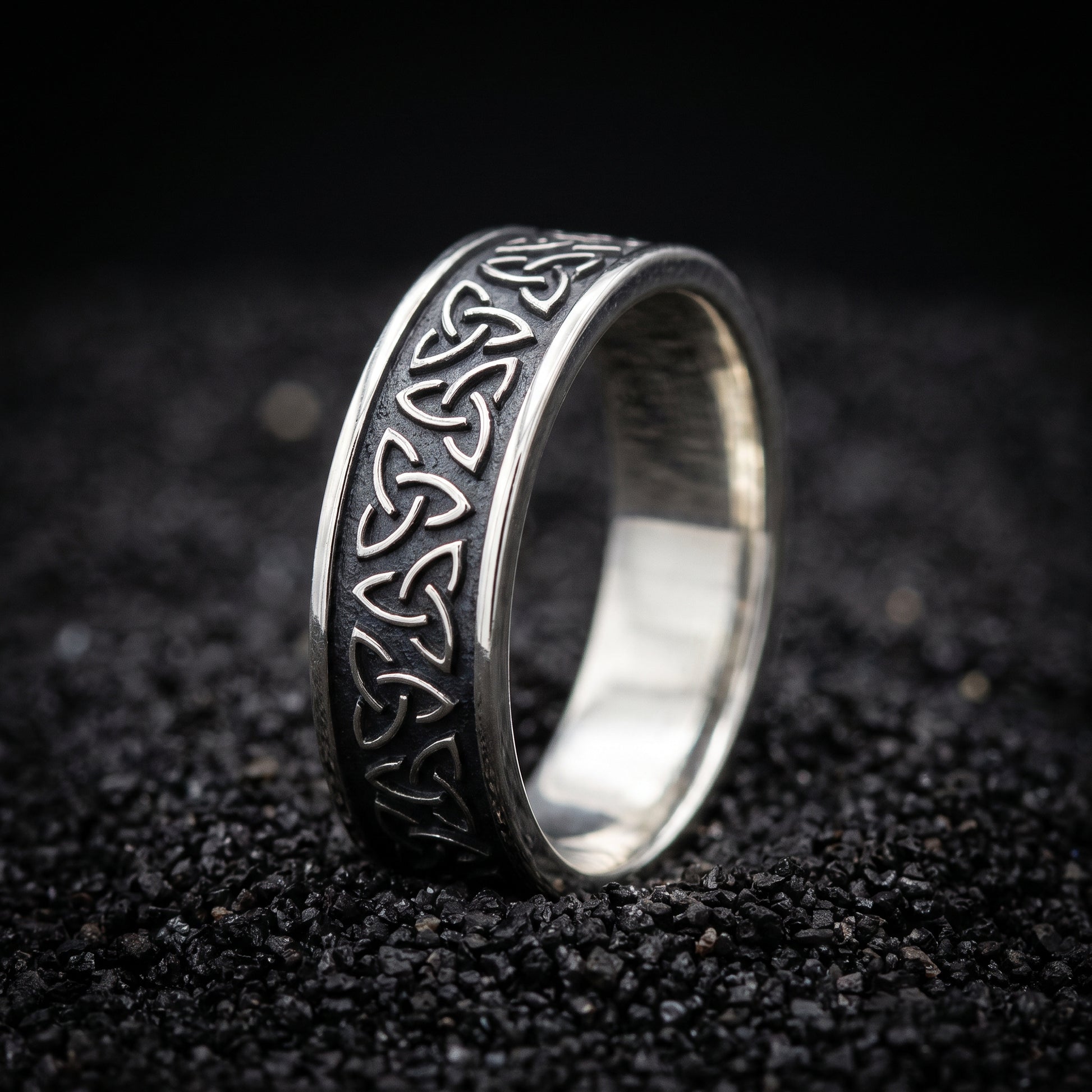 Narrow sterling silver Viking ring with a row of triquetra knots