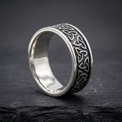 Narrow silver triquetra ring from the side, polished interior visible