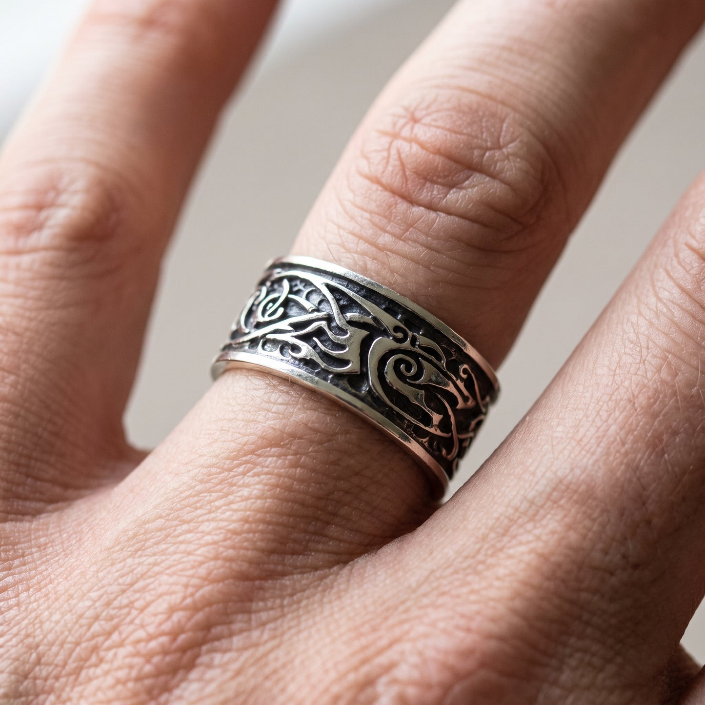 Silver Viking ring with Urnes interlace worn on a finger