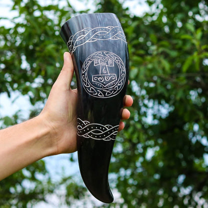 Hand holding the 12 inch Thor's hammer drinking horn outdoors