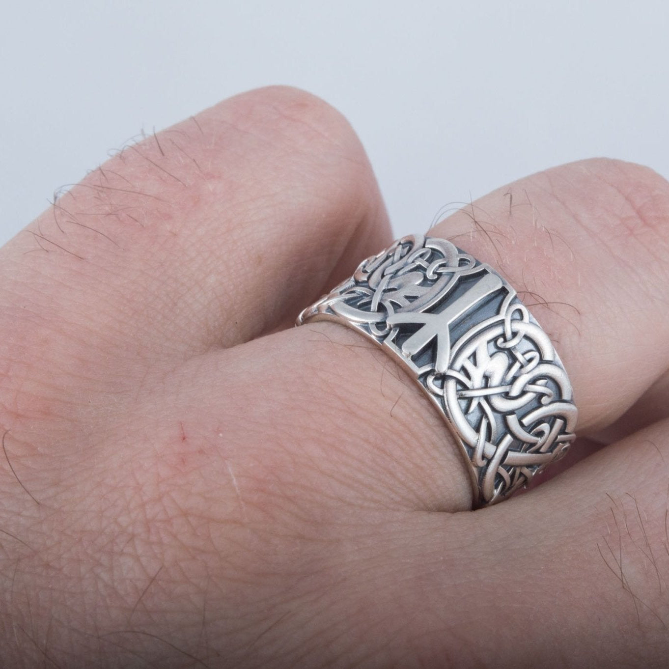 Algiz rune Viking ring photographed on a hand, showing real scale on the finger