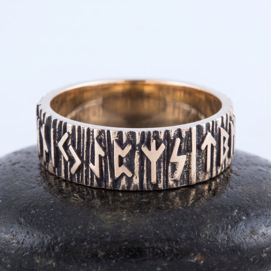 Bronze rune wedding ring seen front on, raised Elder Futhark runes rim to rim