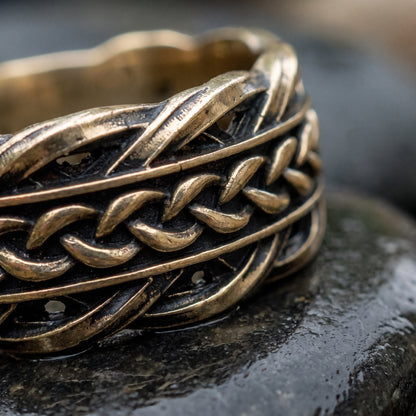 Macro of the woven Scandinavian ornament and dark recesses on the bronze band