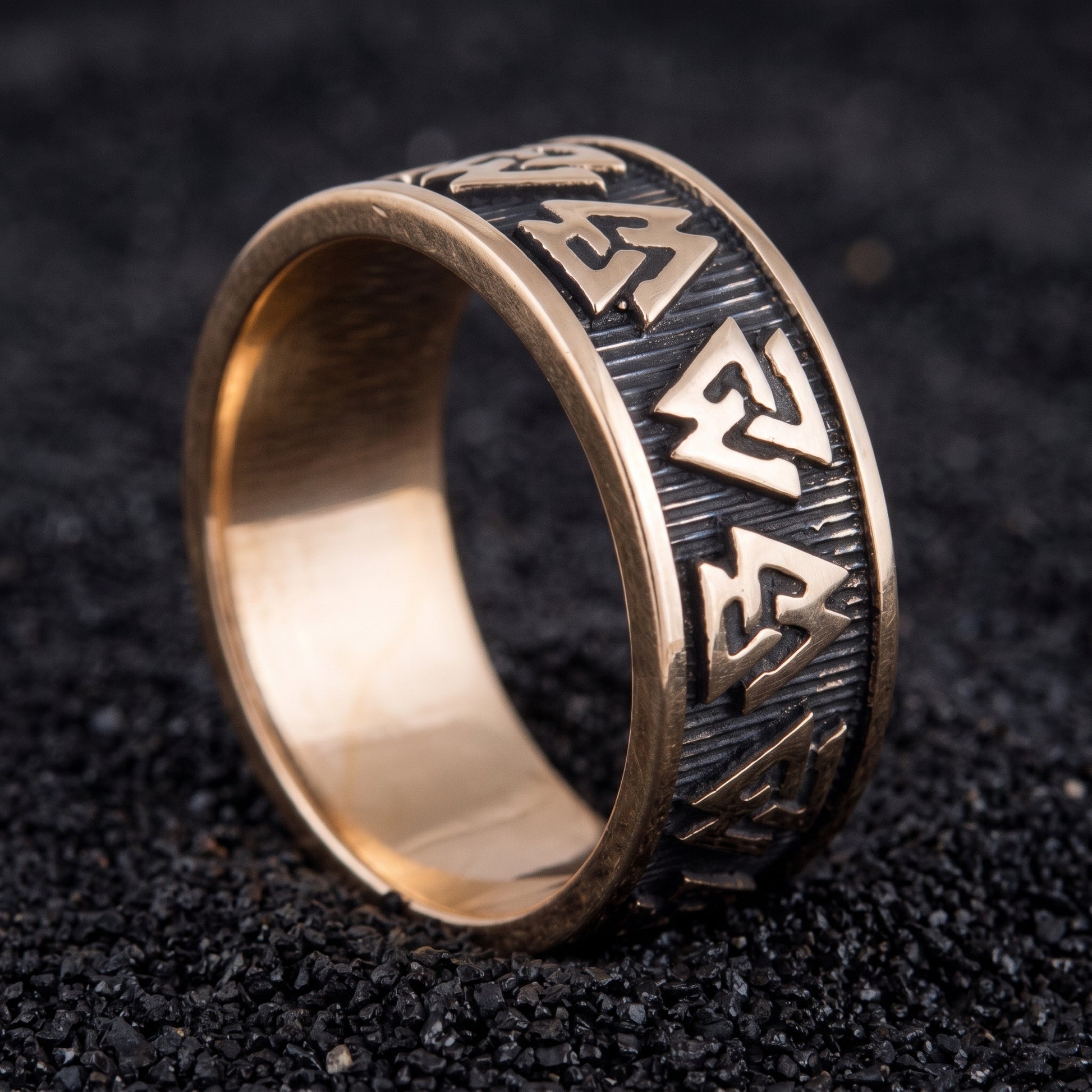 Bronze Valknut Viking ring with three interlocking triangles on black volcanic sand