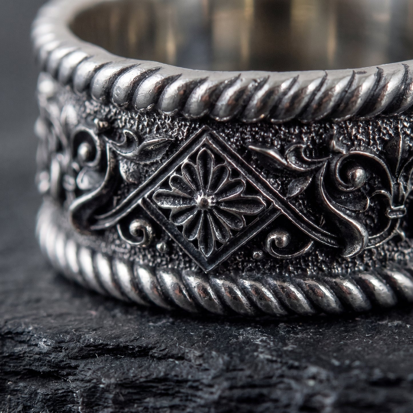 Macro of the carved rosette panel and blackened scrollwork on the 925 silver band