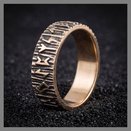 Elder Futhark runes bronze Viking wedding ring on black volcanic sand