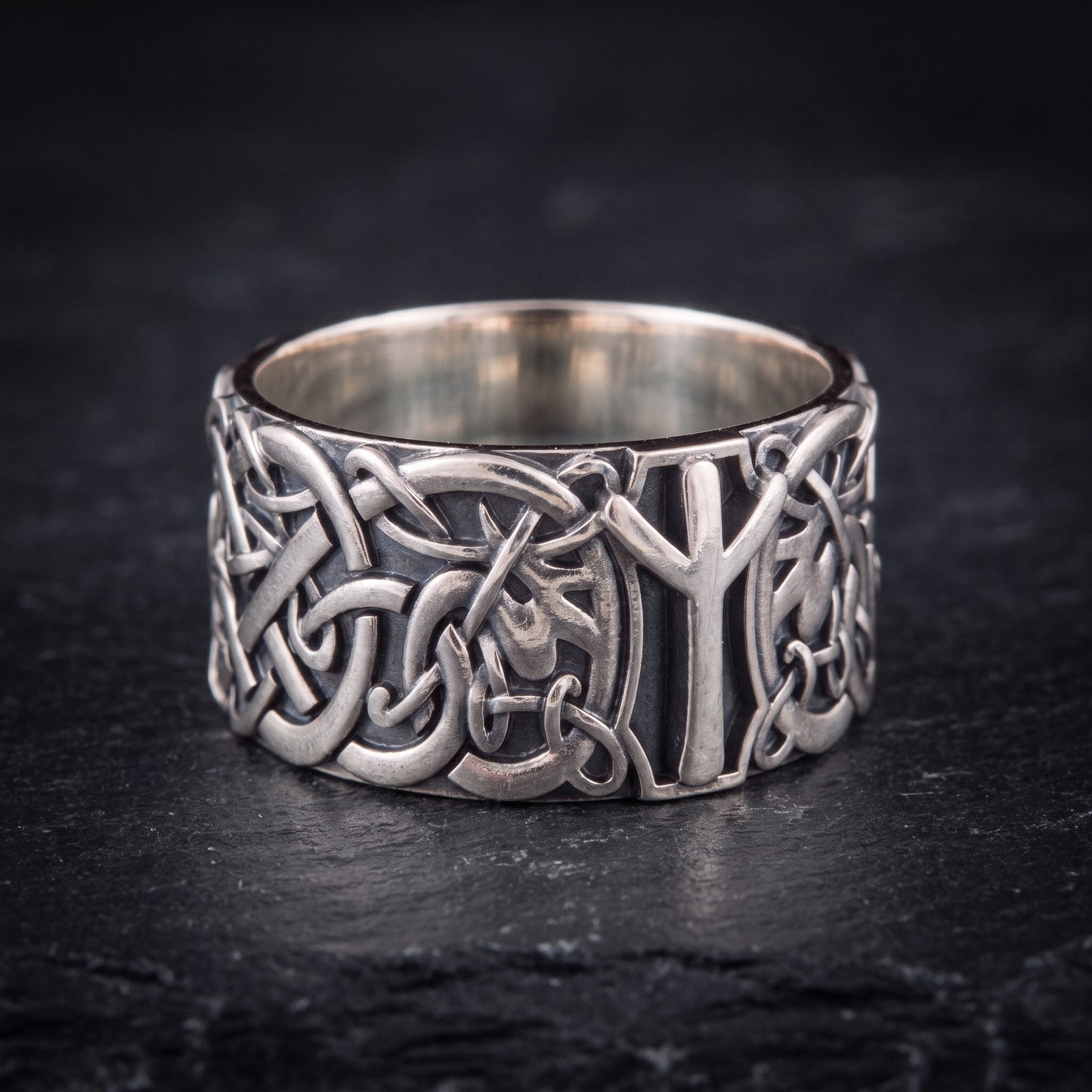 Close view of the openwork Norse knotwork and raised Algiz rune