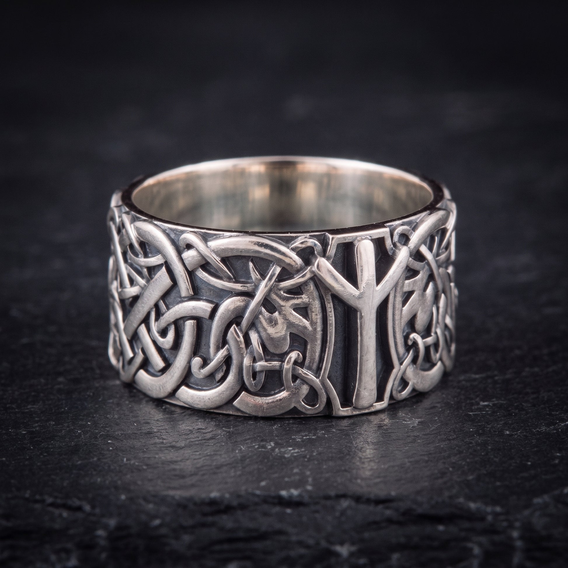 Close view of the openwork Norse knotwork and raised Algiz rune