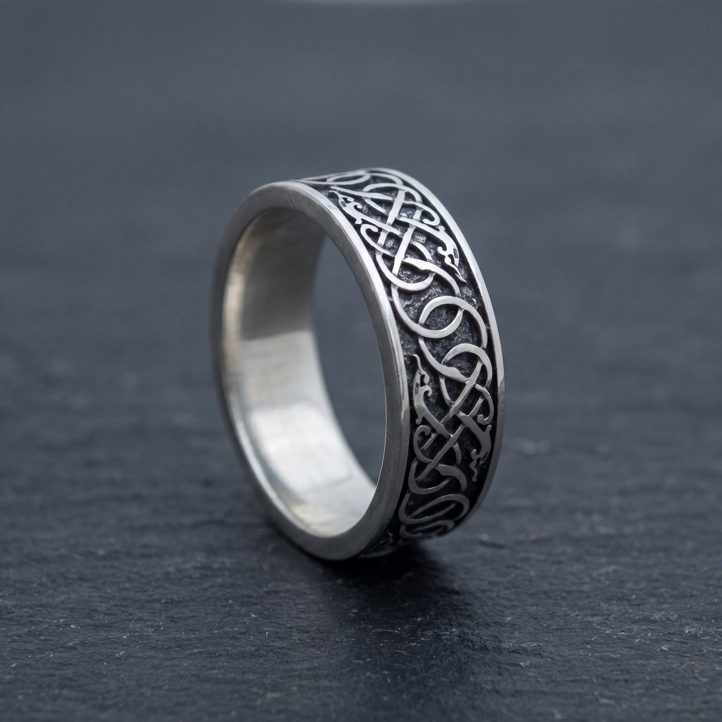 Norse wedding band from the side, interlace wrapping around the polished band