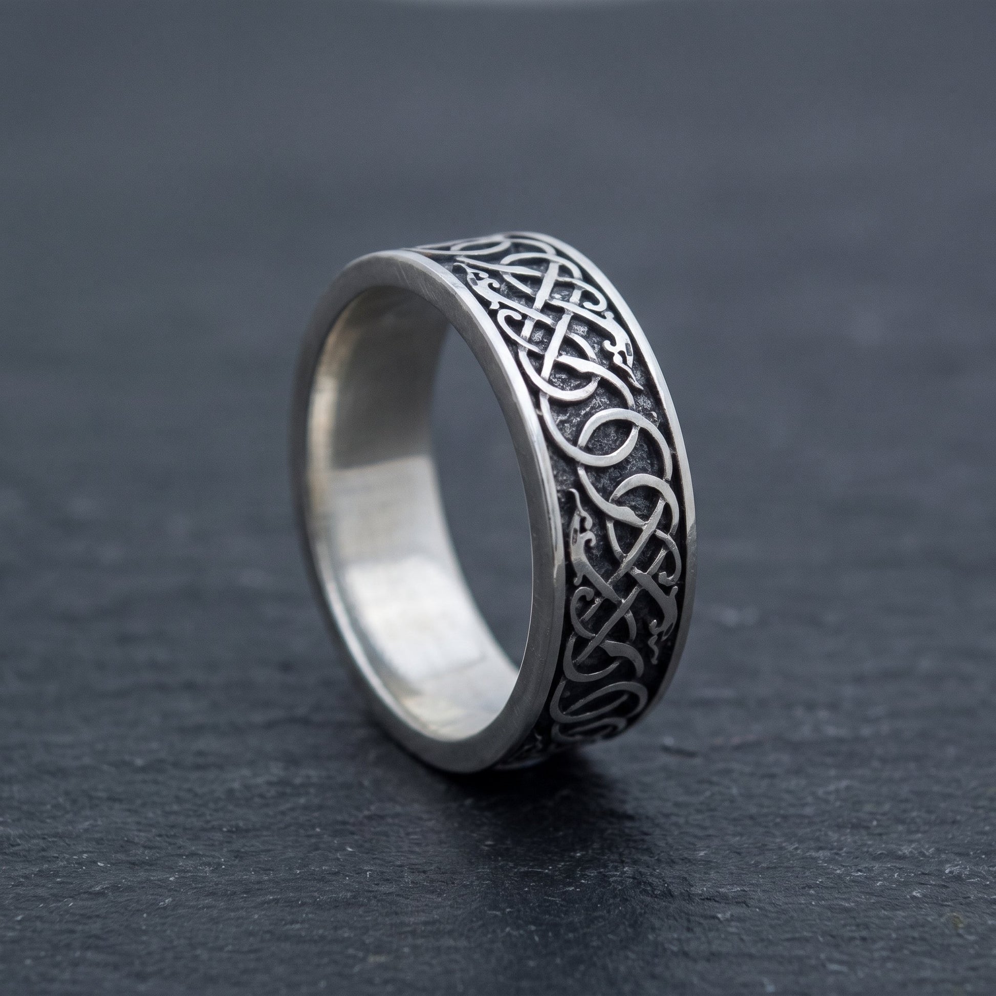 Norse wedding band from the side, interlace wrapping around the polished band