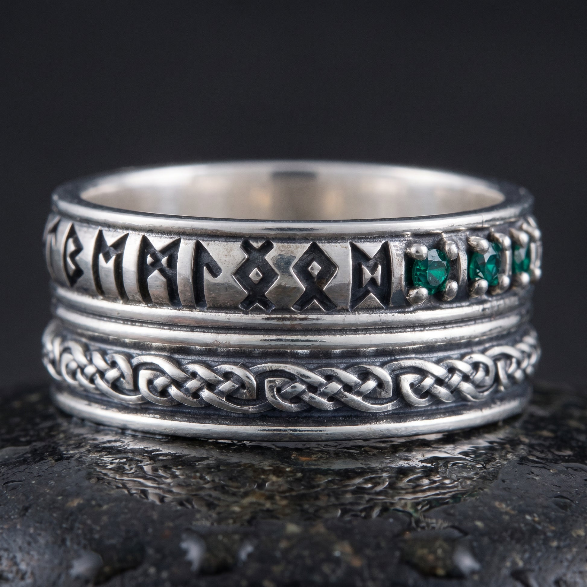 Handmade 925 silver rune ring seen front on, runes, green stones and plaited knotwork band