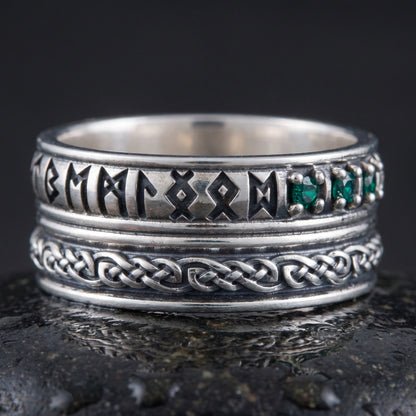 Handmade 925 silver rune ring seen front on, runes, green stones and plaited knotwork band