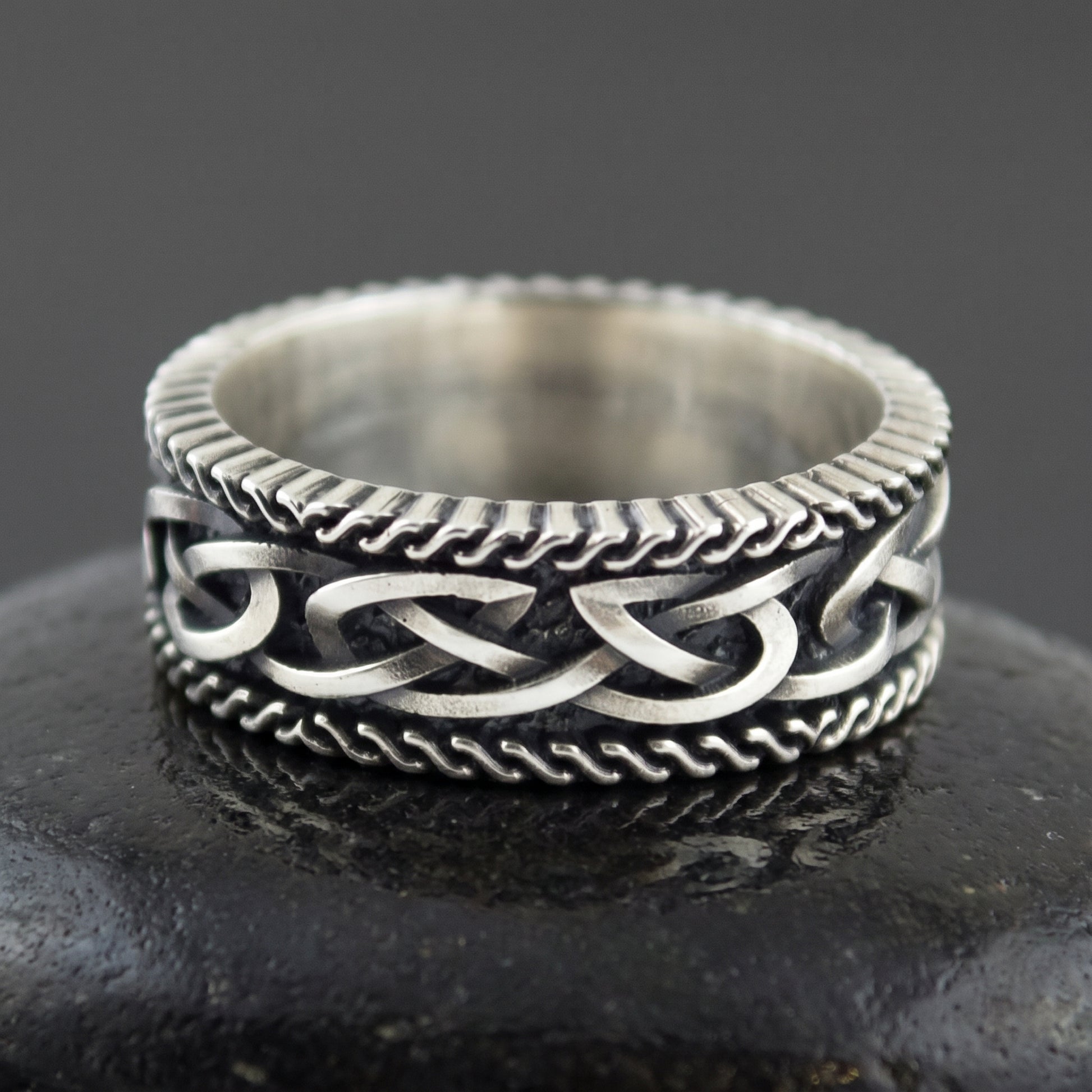 Sterling silver Viking ring seen front on, plaited Norse knot between two twisted rope borders